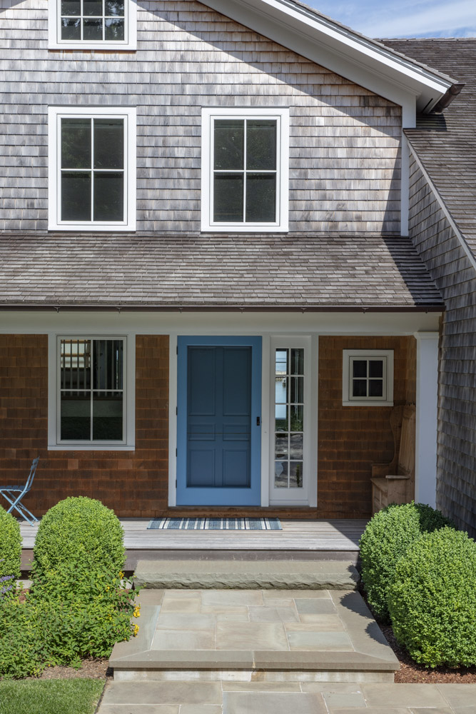 Water Hole blue door welcomes you. Build by Bruce Helier Builders.